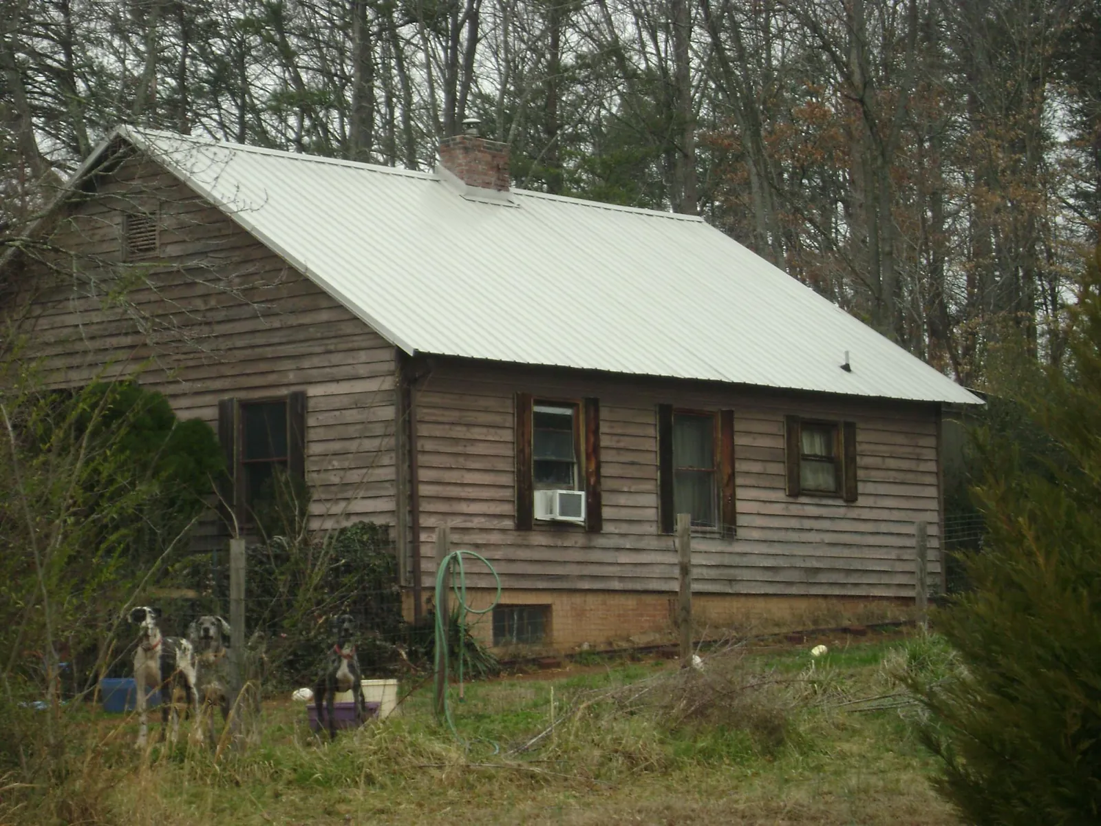 White metal roof on an old wood sided farmhouse, from a Metal Roof Installation job in North Salem